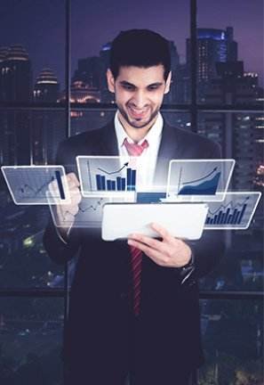 Home 1 virtual data charts on a tablet. Cityscape visible through large windows in the background suggests a modern, innovative setting